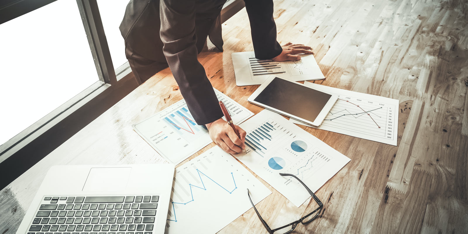 Cyber security consultant with papers spread out on table